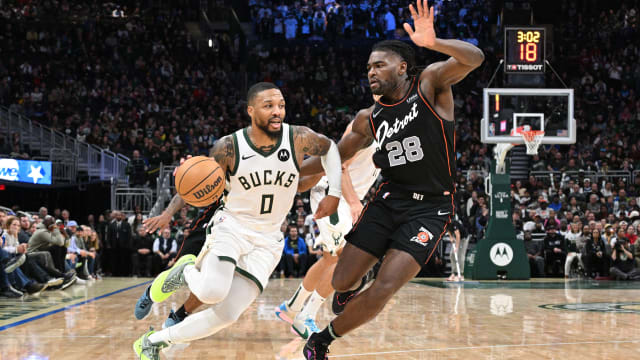 Milwaukee Bucks guard Damian Lillard dribbles to the basket against the Detroit Pistons.